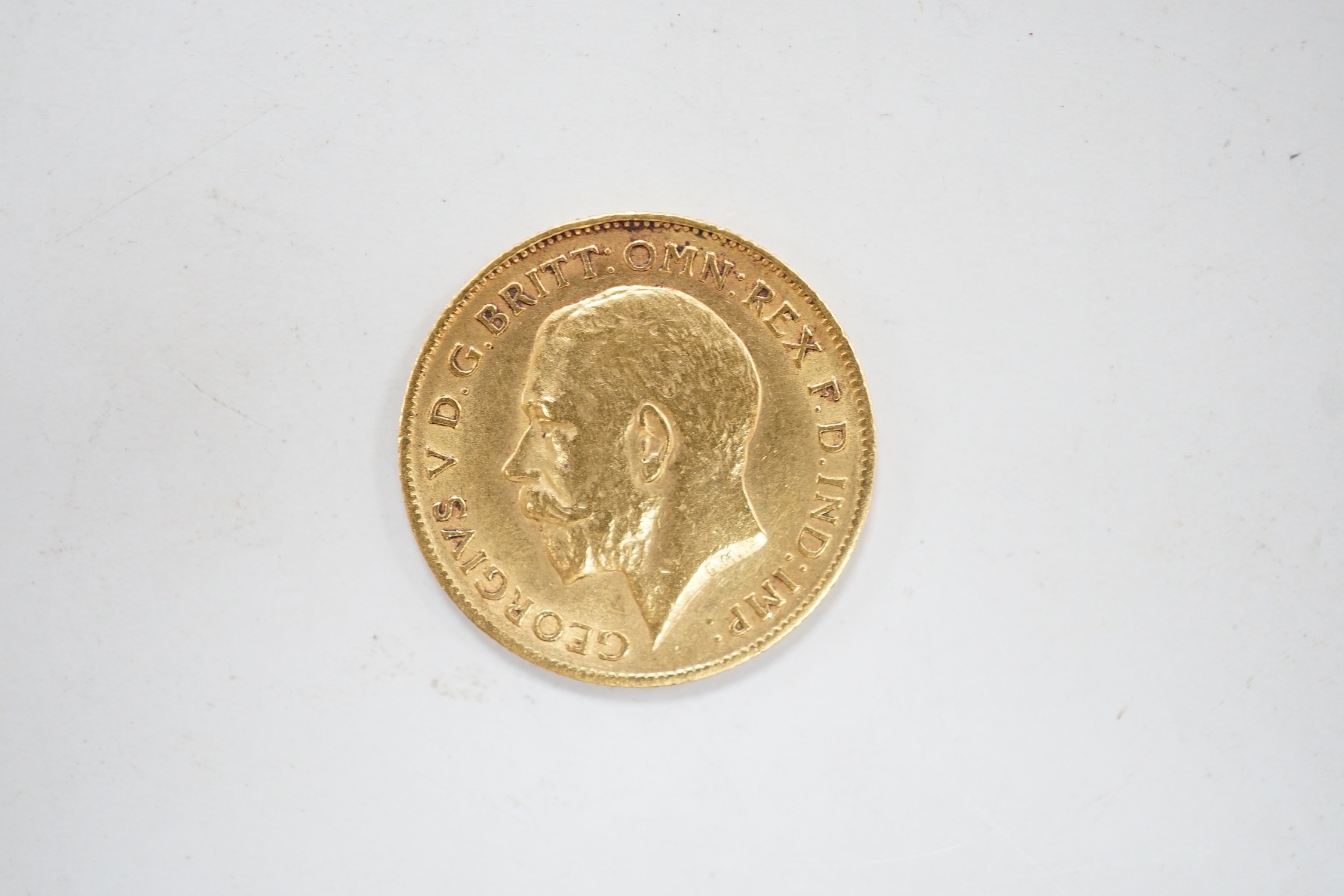 A George V 1911 gold half sovereign, with leather purse.